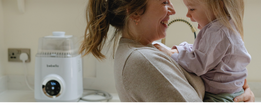 Mum and daughter smiling with Bebello Washer behind