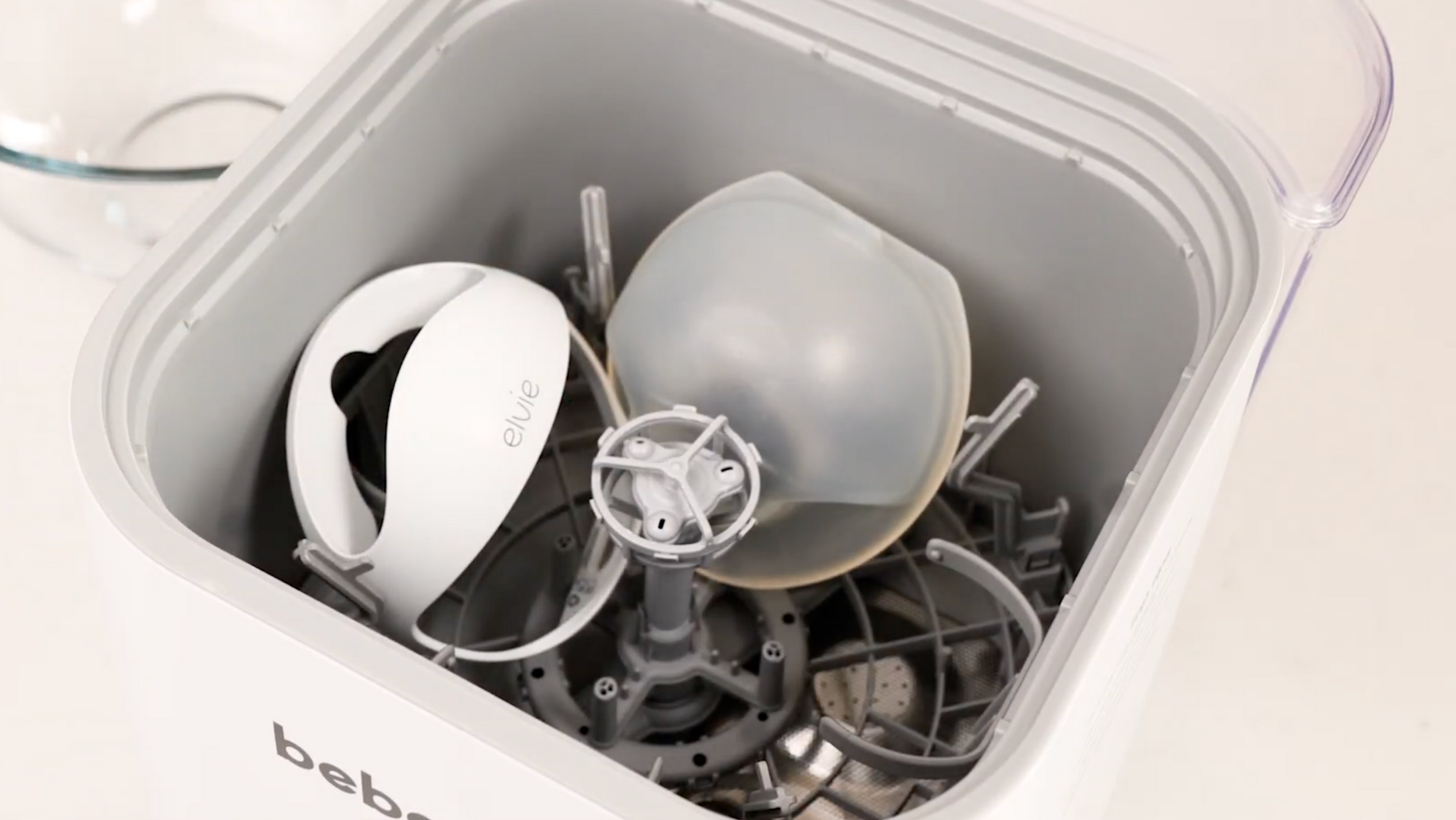 Elvie Curve breast pump placed in bottom tray of Bebello Washer