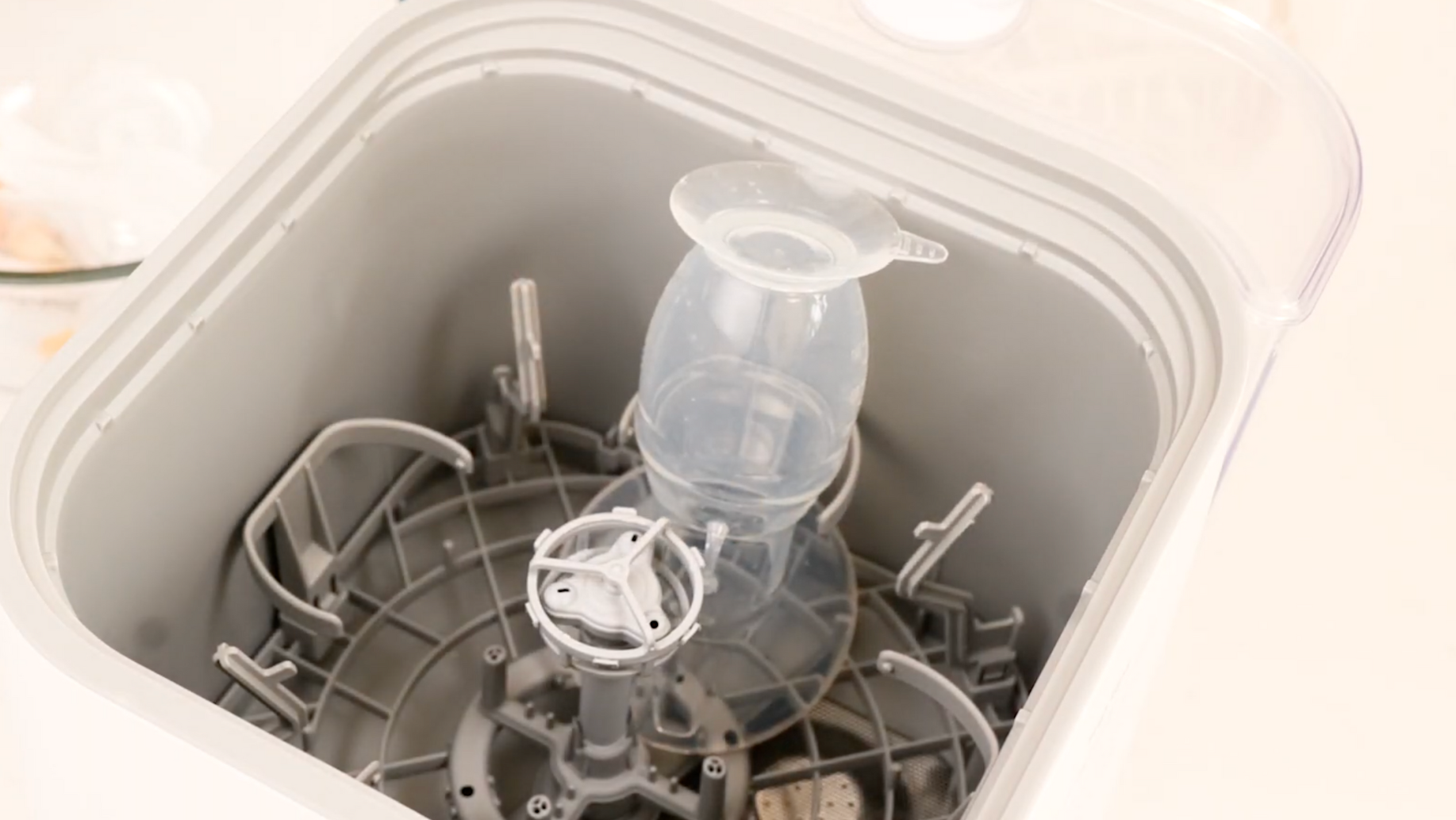 Haakaa breast pump placed in bottom tray of Bebello Washer